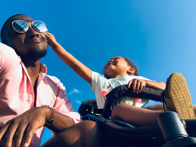 Dad carrying baby using a KoZe carrier